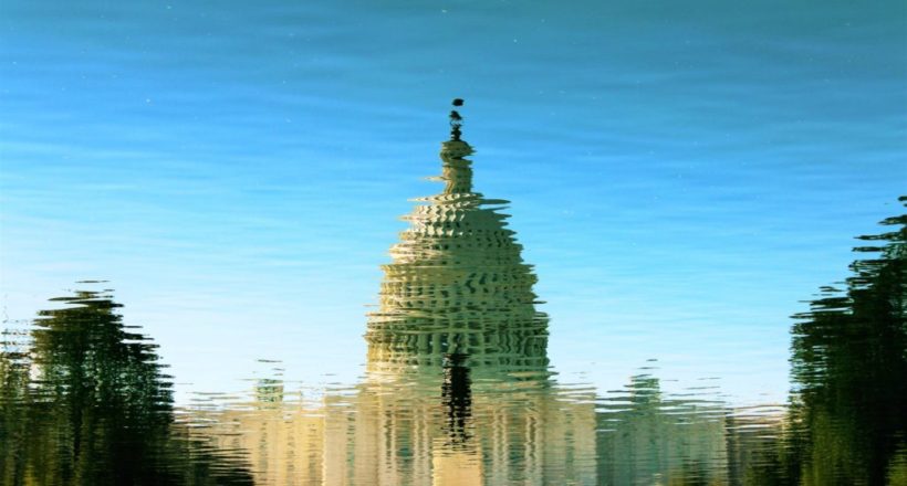 reflection of gray mosque on water