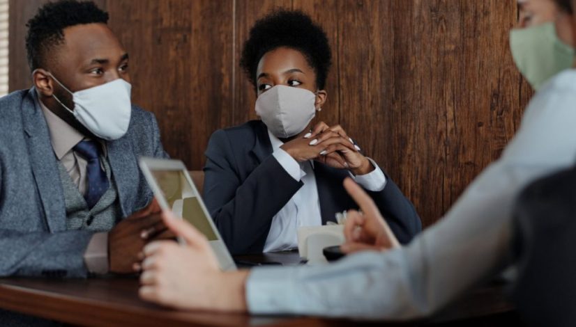 business people wearing face masks and talking