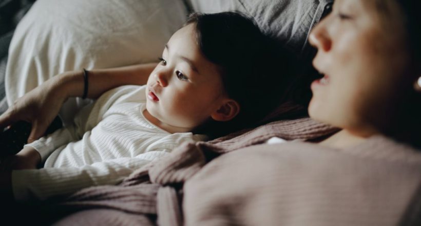 mother and child lying in bed