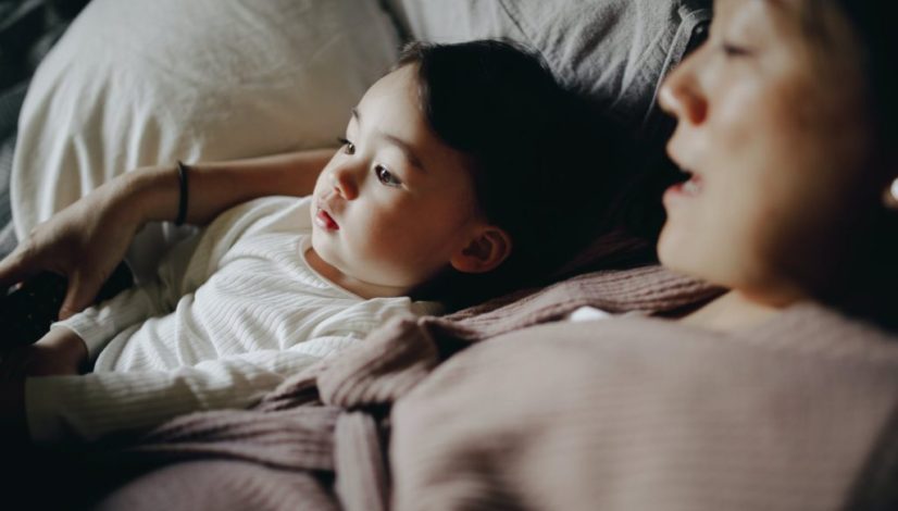 mother and child lying in bed