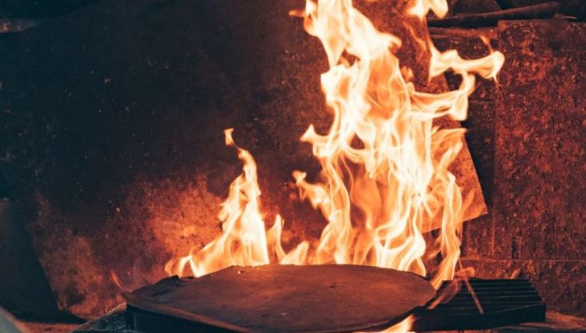 blue corn tortilla roasting in fireplace