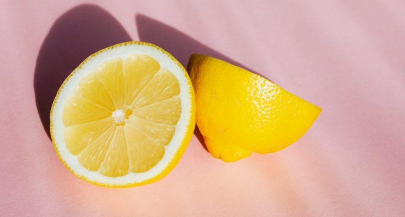 sliced pieces of lemon on pink surface