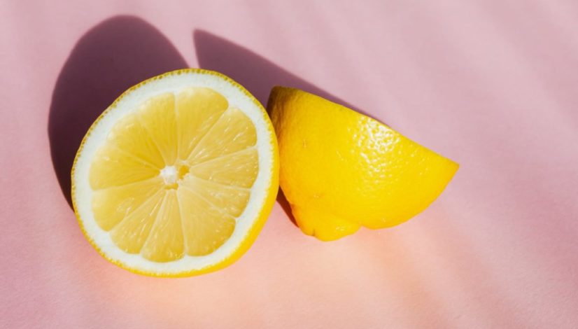 sliced pieces of lemon on pink surface