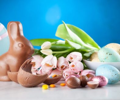 white flowers between brown rabbit figure and eggs