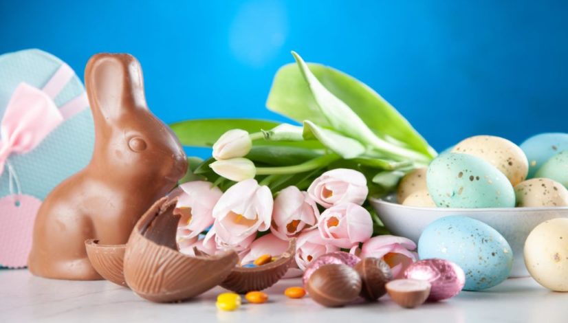 white flowers between brown rabbit figure and eggs